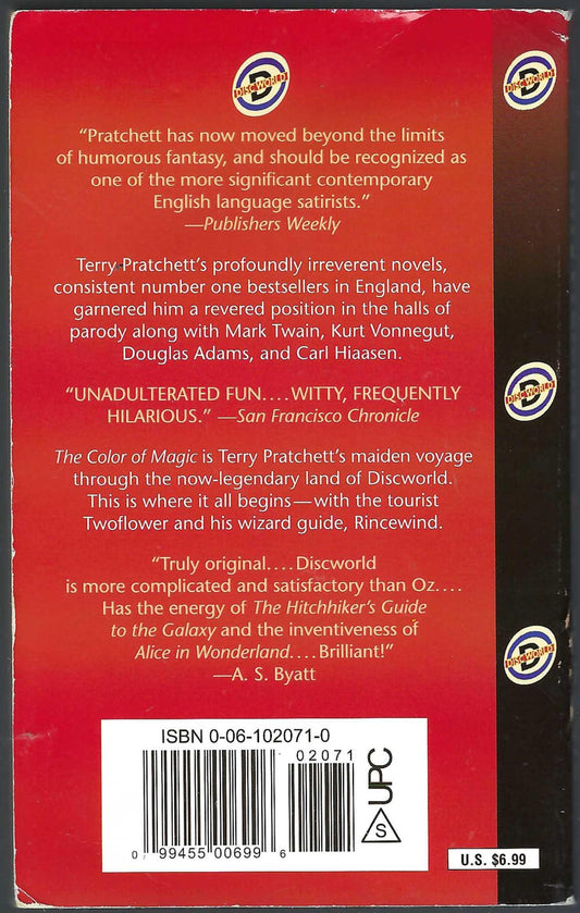 Back cover of The Color of Magic by Terry Pratchett, featuring a red background with white review quotes, a barcode.