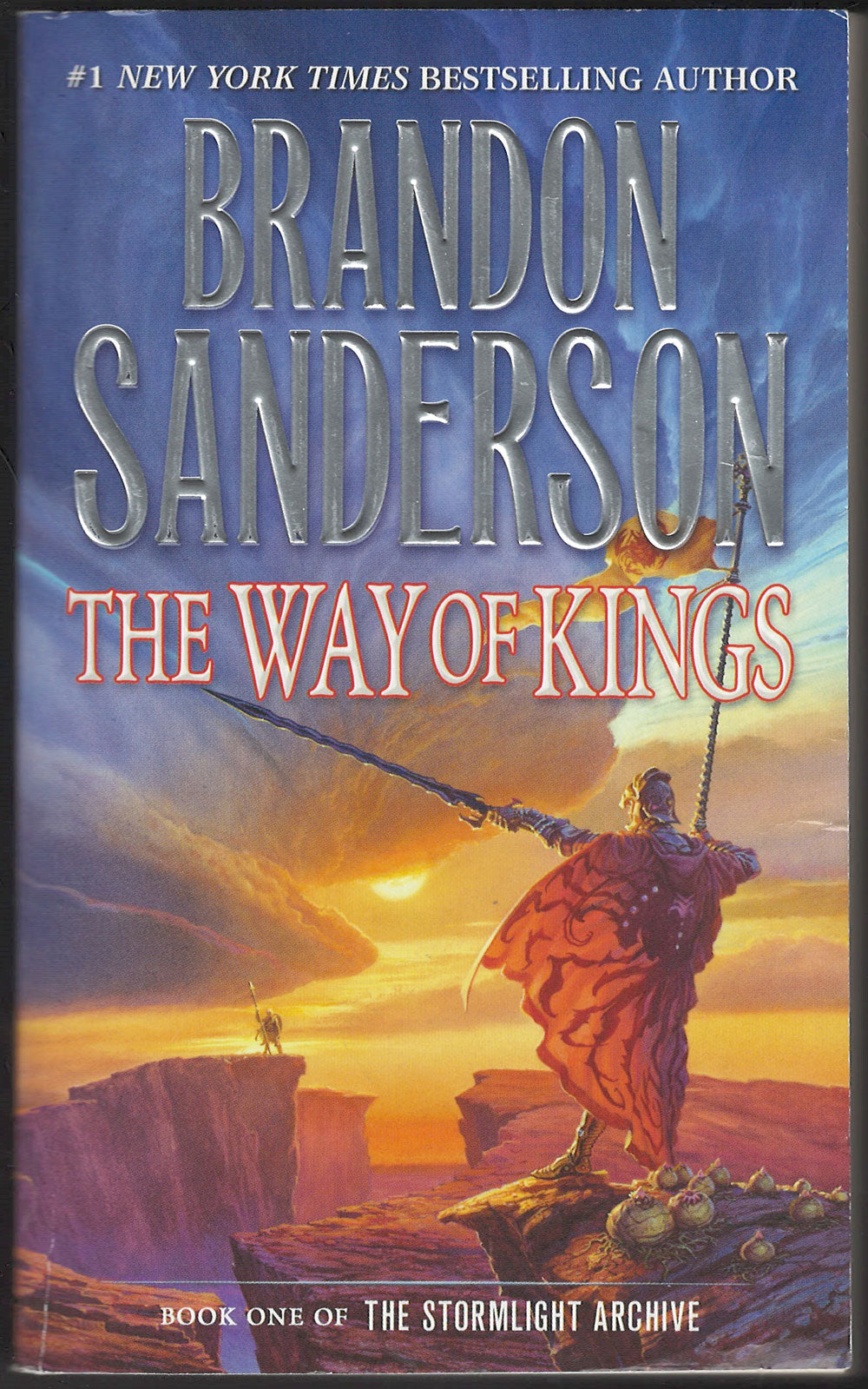 Front cover of The Way of Kings by Brandon Sanderson with a warrior on a cliff at sunset.