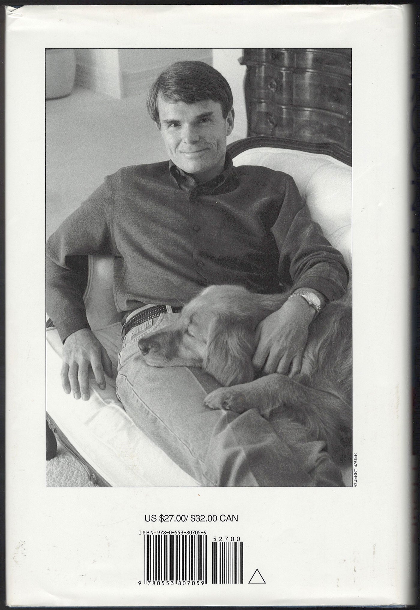 Odd Hours by Dean Koontz back cover with a photo of the author sitting on a couch with his dog.
