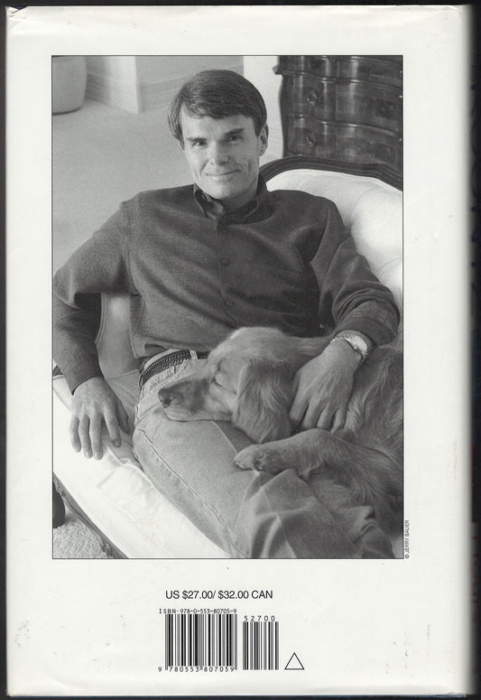 Odd Hours by Dean Koontz back cover with a photo of the author sitting on a couch with his dog.