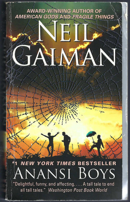 Front cover of Anansi Boys by Neil Gaiman with a sunset and spider web design.