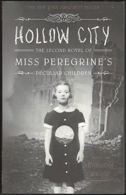 Front cover of Hollow City by Ransom Riggs featuring a peculiar image of a young girl in a black dress.