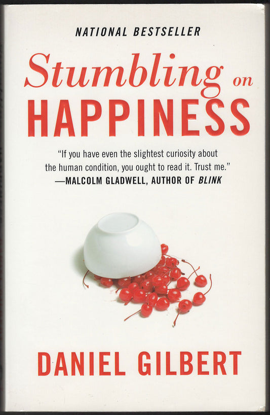 Front cover of Stumbling on Happiness by Daniel Gilbert with an overturned white bowl and cherries.