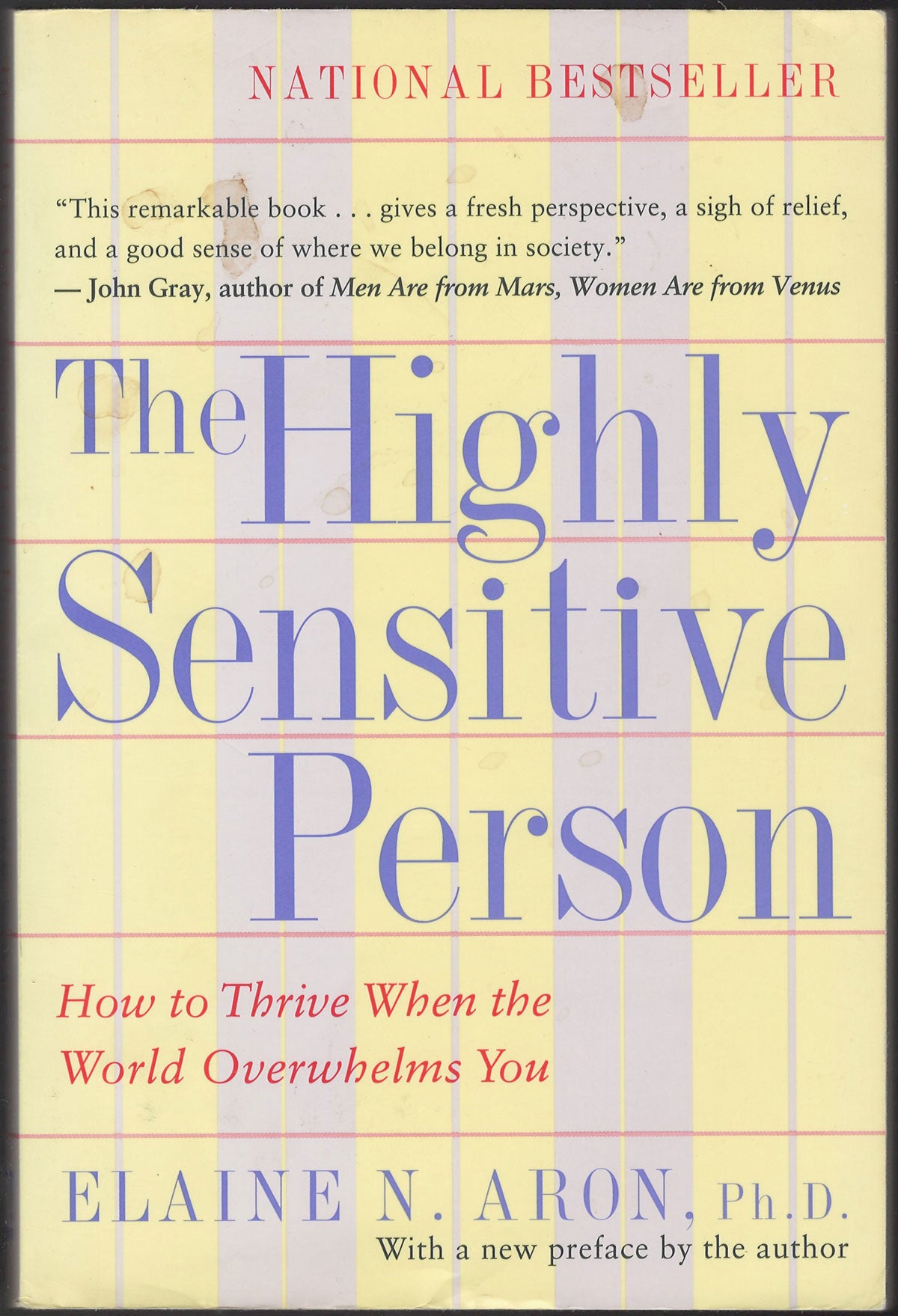 Front cover of The Highly Sensitive Person by Elaine N. Aron with a yellow and purple striped background.