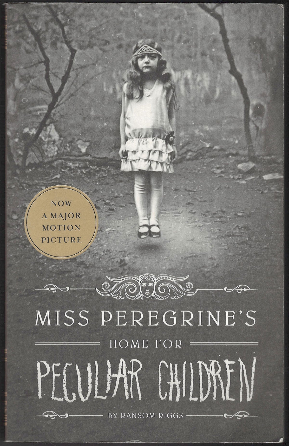 Front cover of Miss Peregrine's Home for Peculiar Children by Ransom Riggs with a vintage-style image of a girl.