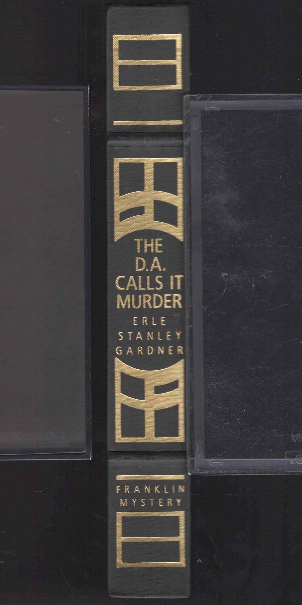 Spine of The D.A. Calls It Murder by Erle Stanley Gardner with gold lettering on a black background