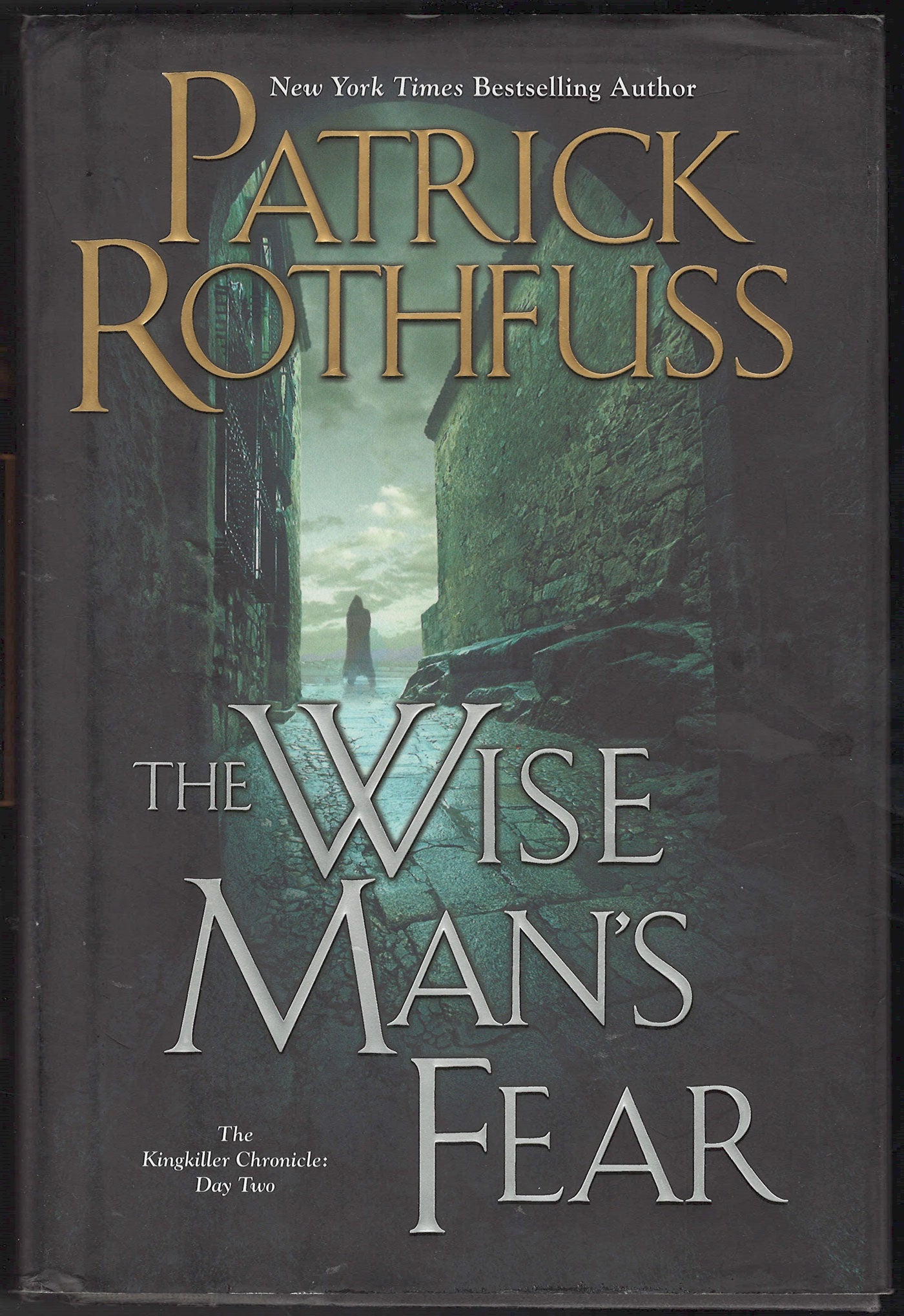 Front cover of The Wise Man's Fear by Patrick Rothfuss, showing a dark alley scene with large gold and silver text.