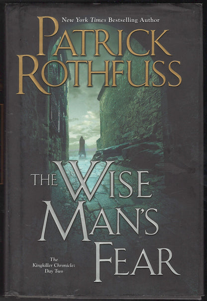 Front cover of The Wise Man's Fear by Patrick Rothfuss, showing a dark alley scene with large gold and silver text.