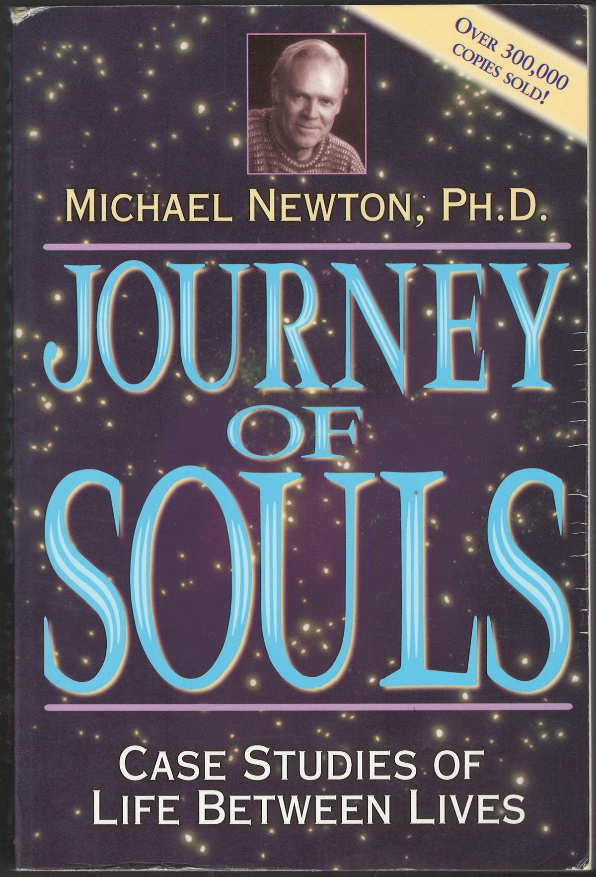 Front cover of Journey of Souls by Michael Newton with a starry background and portrait of the author.