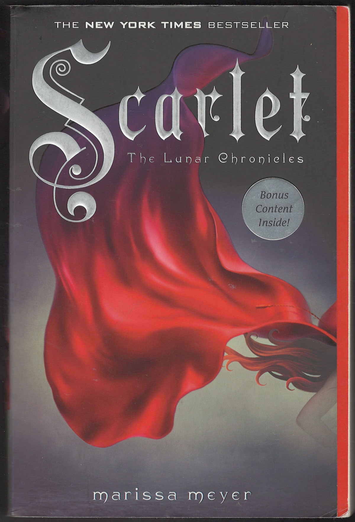 Front cover of Scarlet by Marissa Meyer with an image of red cape.