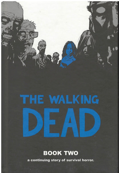 Front cover of The Walking Dead: Book Two by Robert Kirkman with zombie silhouettes and blue text.