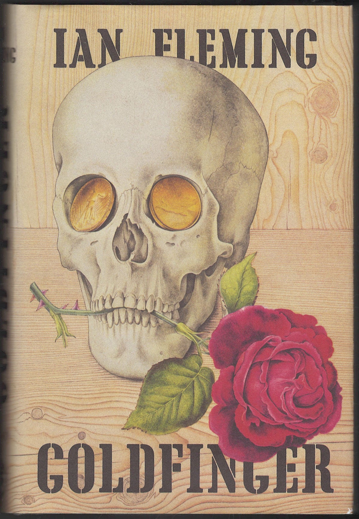Front cover of Goldfinger by Ian Fleming featuring a skull and rose on a wooden texture background.