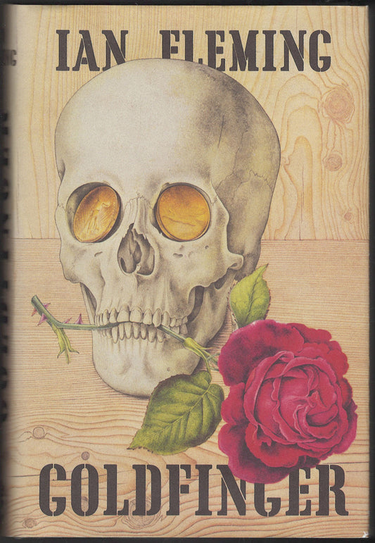 Front cover of Goldfinger by Ian Fleming featuring a skull and rose on a wooden texture background.