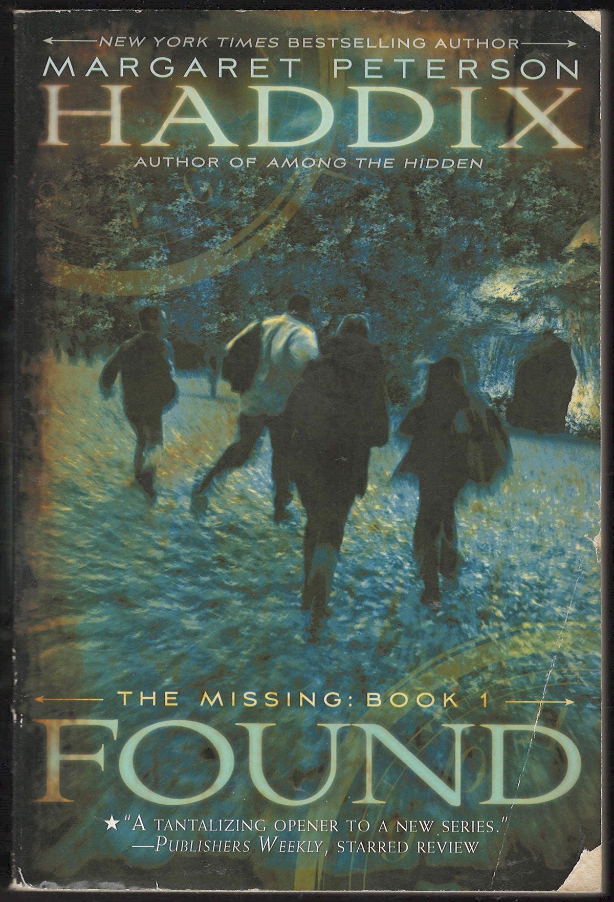 Front cover of Found by Margaret Peterson Haddix, featuring a dark, snowy forest scene with several figures running through the snow. 