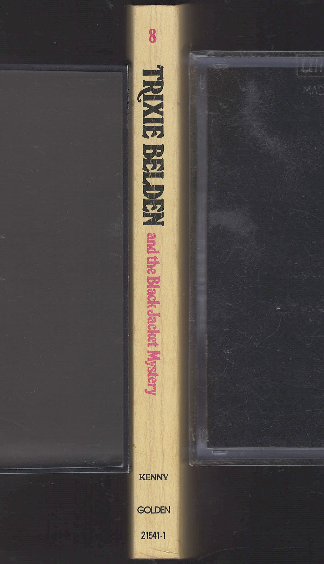 Book titled 'Trixie Belden and the Black Jacket Mystery' by Kenny, published by Golden Books.