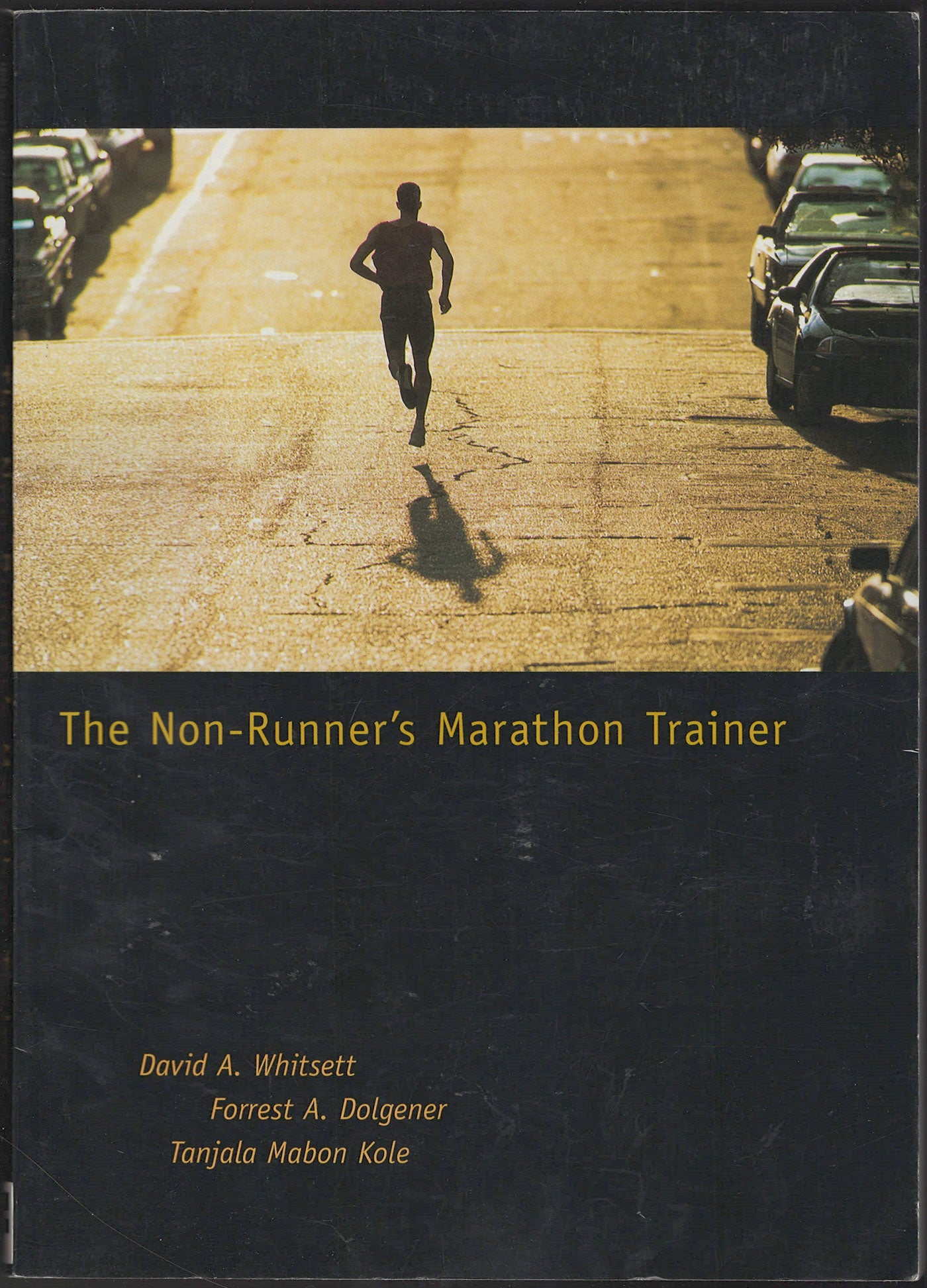 Front cover of The Non-Runner's Marathon Trainer with a runner on a road.