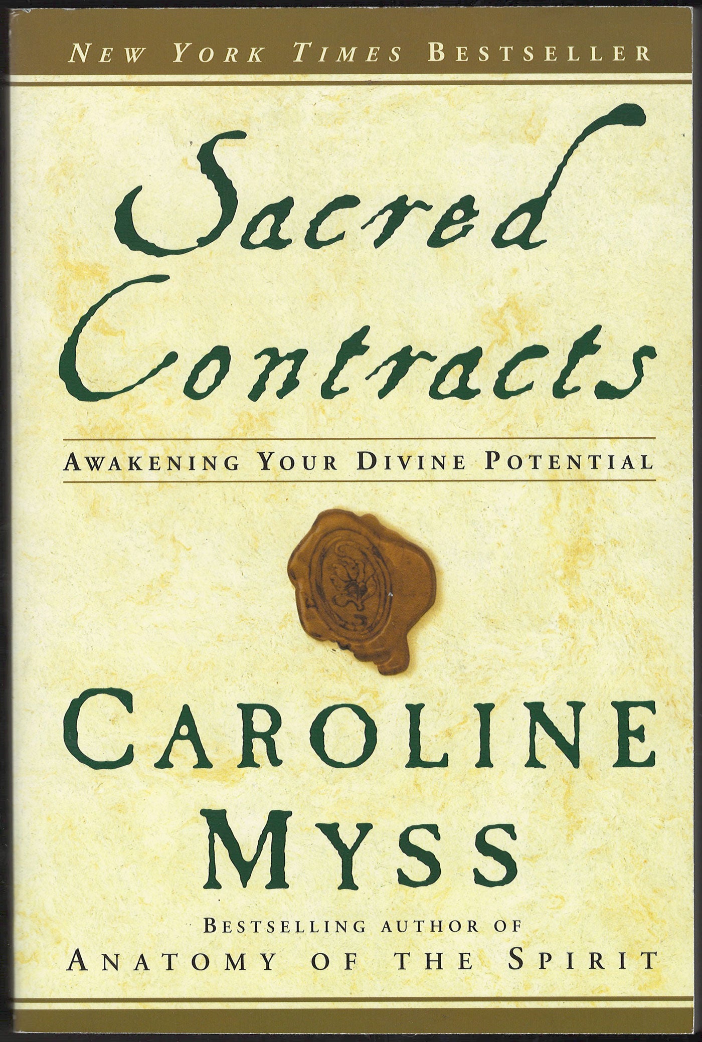 Front cover of Sacred Contracts by Caroline Myss with an image of a wax seal on a beige background.