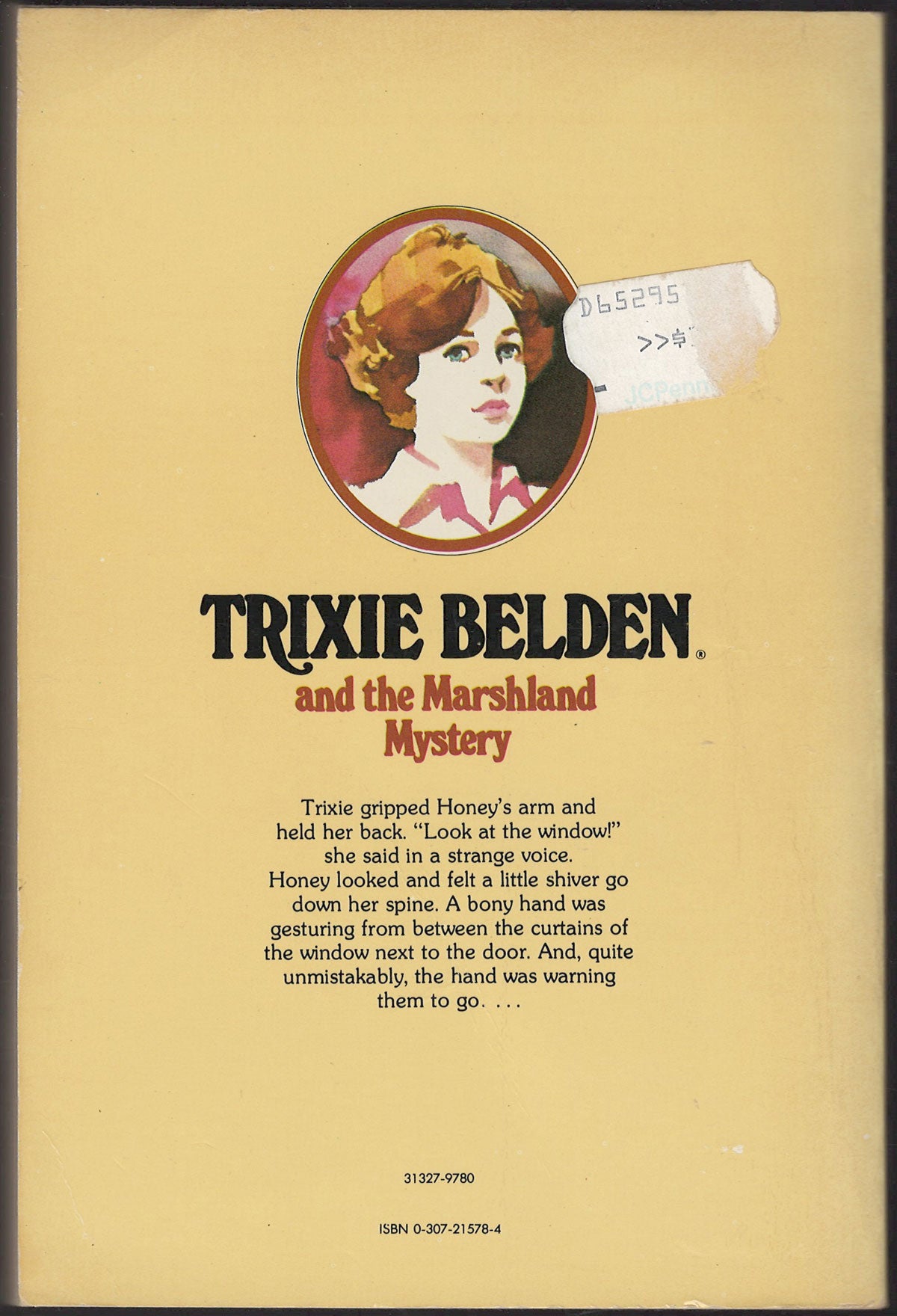 Back cover of Trixie Belden and the Marshland Mystery with a portrait of Trixie