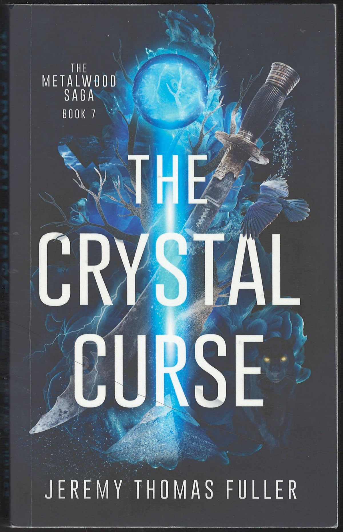 Front cover of The Crystal Curse by Jeremy Thomas Fuller, featuring a dark gray background with a glowing blue crystal and metallic fantasy elements, including a sword hilt and bird.