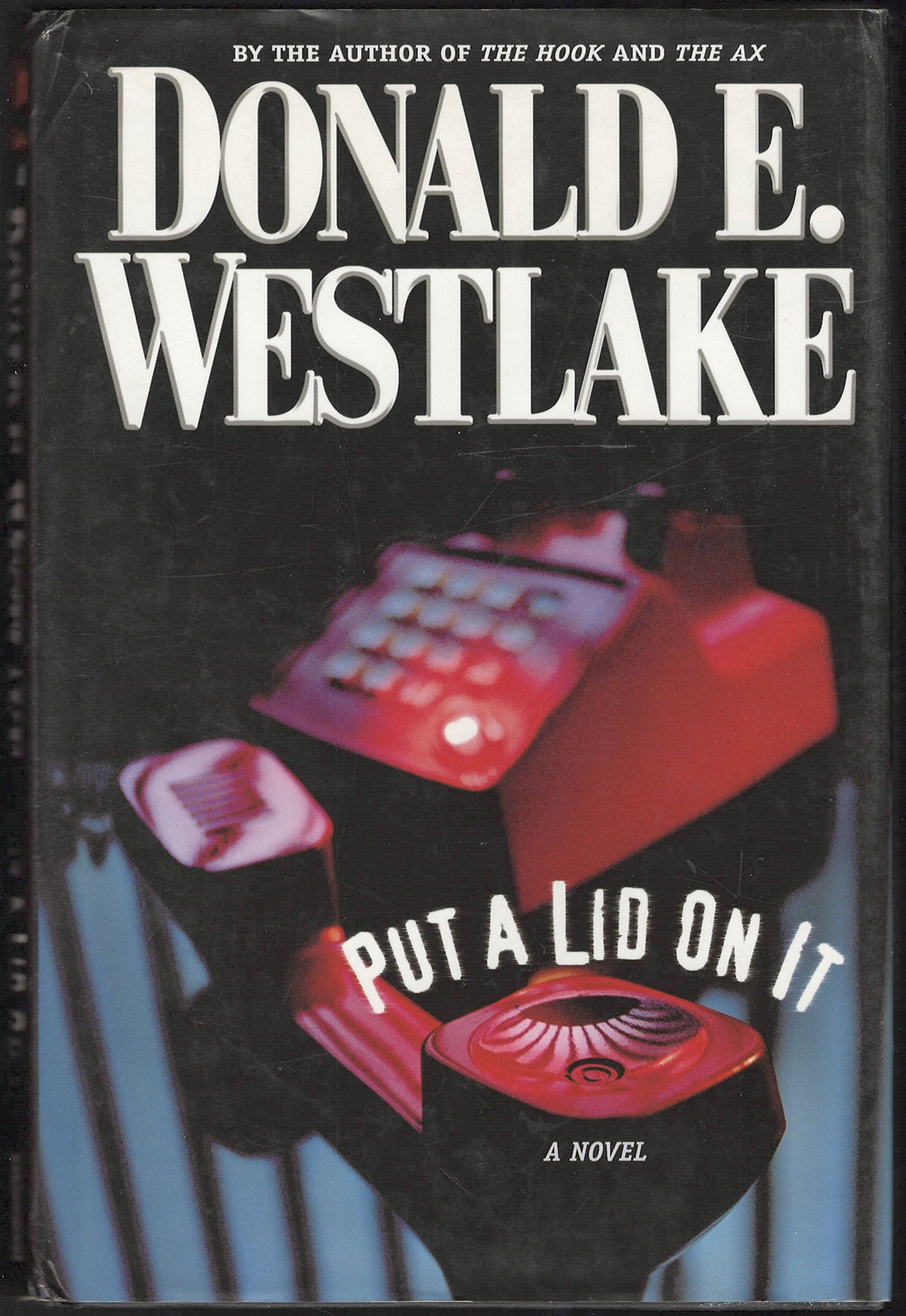 Front cover of Put a Lid on It by Donald E. Westlake featuring a red telephone.