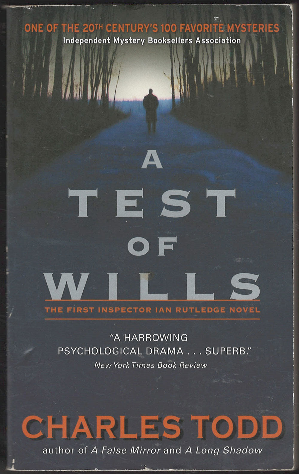 Front cover of A Test of Wills by Charles Todd with a silhouette of a person walking down a path.