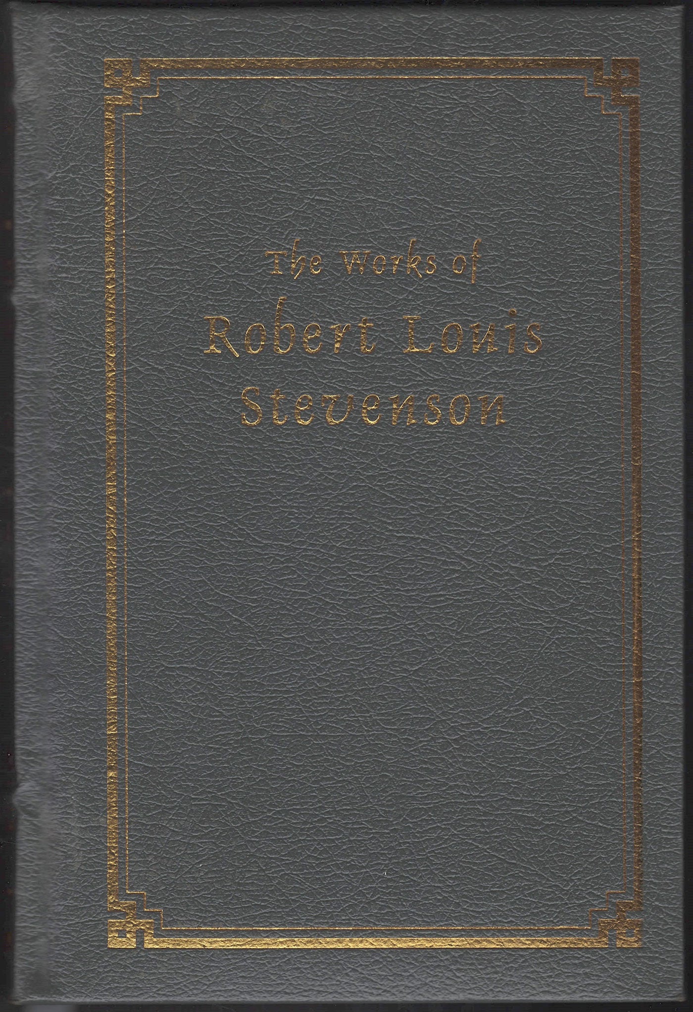 Gray leather-bound book with gold embossed text on the cover
