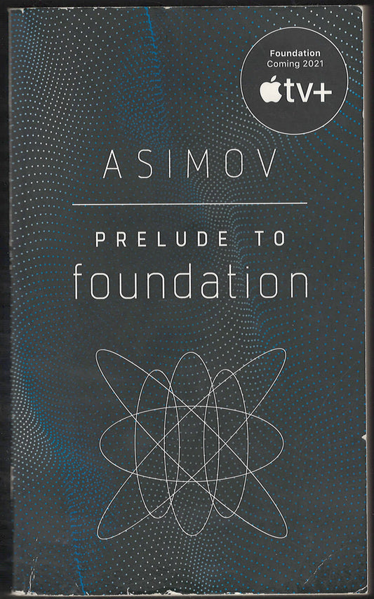 Front cover of Prelude to Foundation by Isaac Asimov with a stylized atom symbol on a dark background.