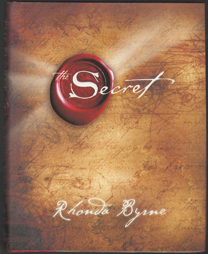 Front cover of The Secret by Rhonda Byrne with a red seal design on a textured background.