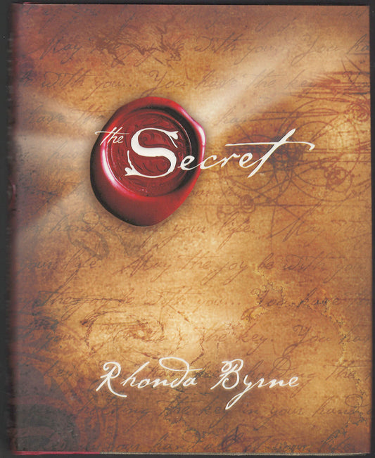 Front cover of The Secret by Rhonda Byrne with a red seal design on a textured background.