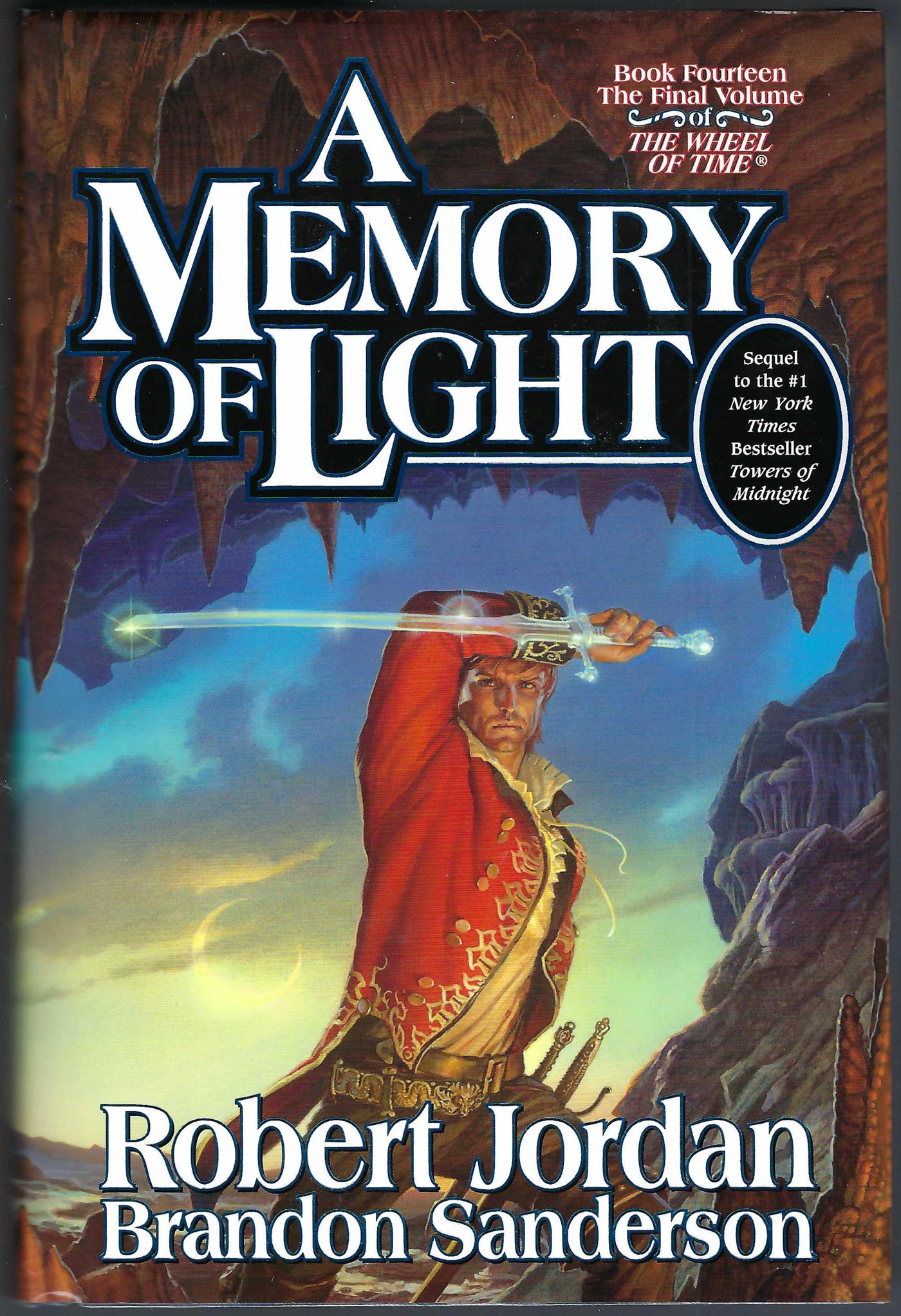 Front cover of A Memory of Light by Robert Jordan and Brandon Sanderson, showing a fantasy scene with a robed figure holding a glowing sword against a dramatic blue and brown background.