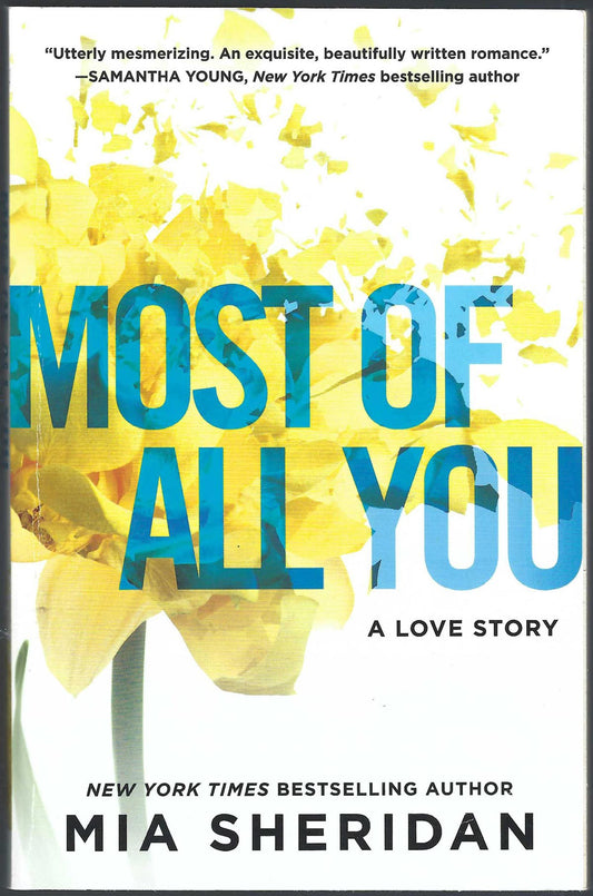 Front cover for Most of All You: A Love Story by Mia Sheridan, featuring large blue title text over a white background with a yellow flower.