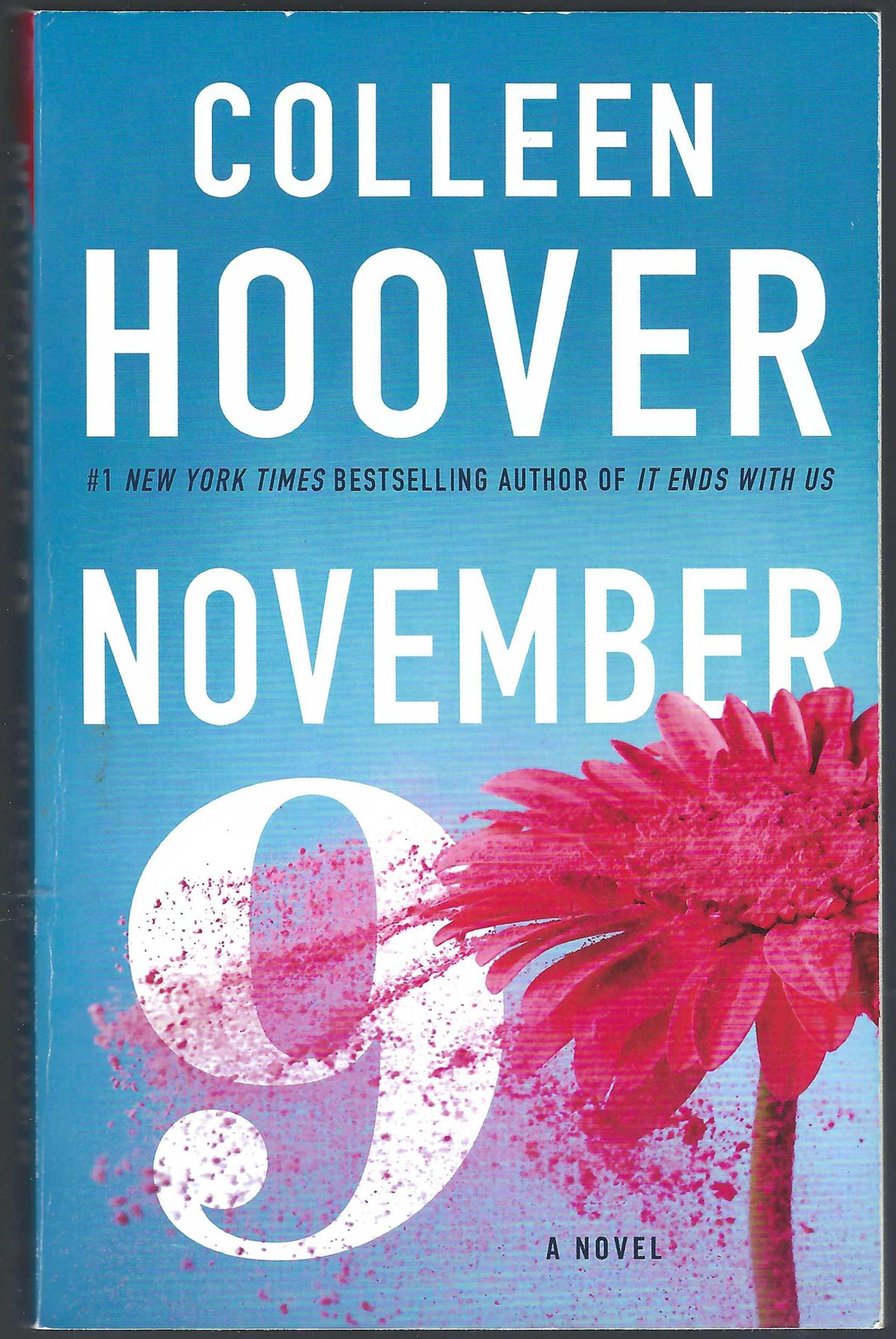 Front cover of November 9 by Colleen Hoover with a pink flower on a blue background