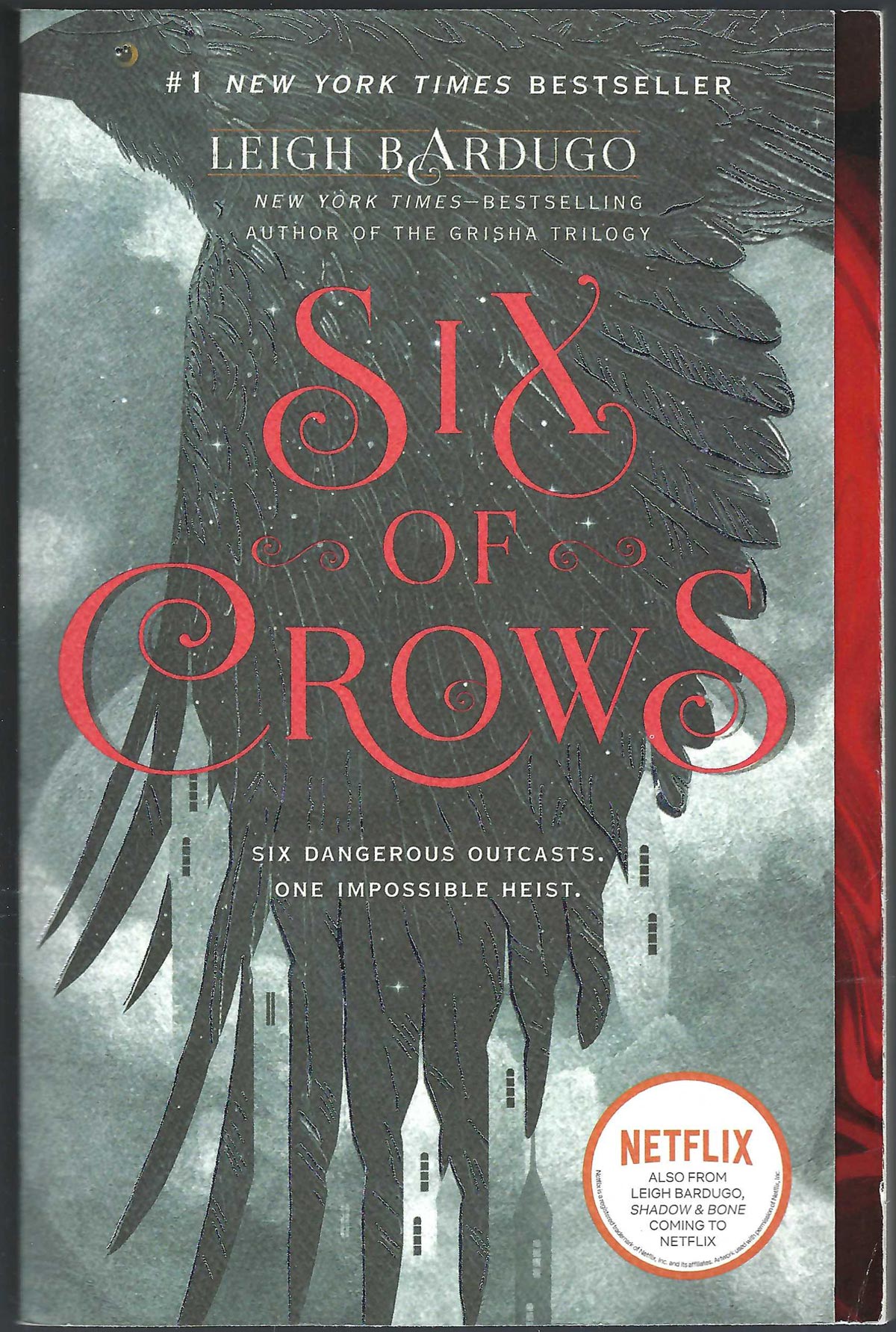 Front cover of Six of Crows by Leigh Bardugo with a crow in flight and red text.