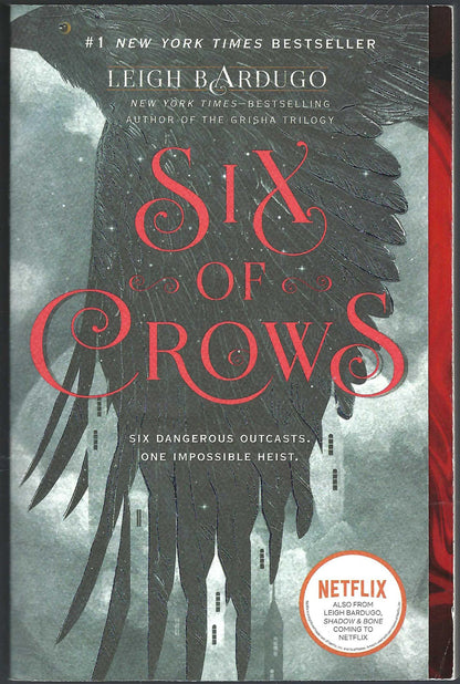 Front cover of Six of Crows by Leigh Bardugo with a crow in flight and red text.